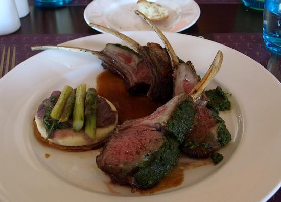 Herb crusted rack of Colorado lamb, presented with a Nicoise-style tart with goat cheese, onions and asparagus